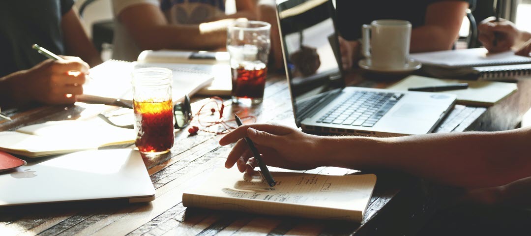 student with his hand on desk